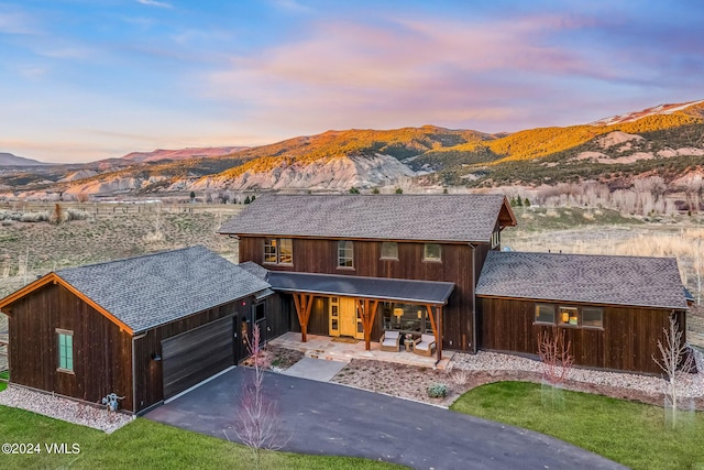 367 Hunters View Ln, Eagle, CO 81631 - rustic home with a mountain view, an attached garage, driveway, and a porch
