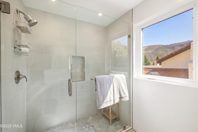 bathroom featuring a shower stall, a mountain view, and recessed lighting