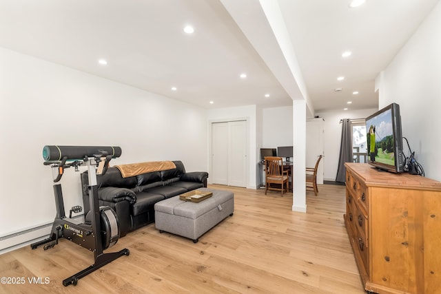 living area with light wood-style floors, recessed lighting, and baseboard heating