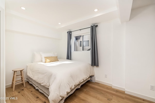 bedroom with light wood-type flooring, recessed lighting, and baseboards