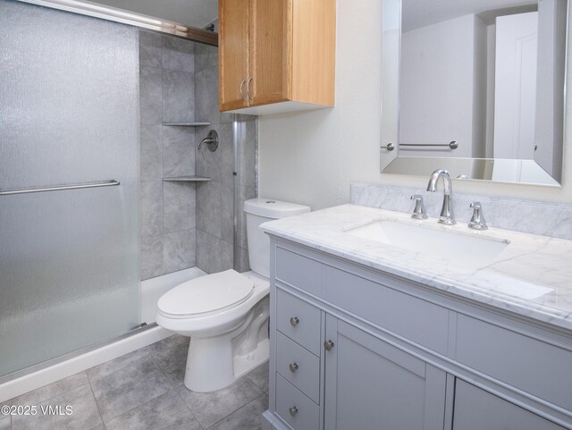 1404 Crazy Horse Cir Unit 1404, Edwards, CO 81632 - full bathroom with vanity, a stall shower, toilet, and tile patterned flooring