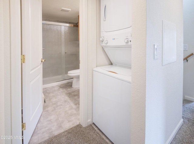 1404 Crazy Horse Cir Unit 1404, Edwards, CO 81632 - laundry area with stacked washer / dryer and light tile patterned floors