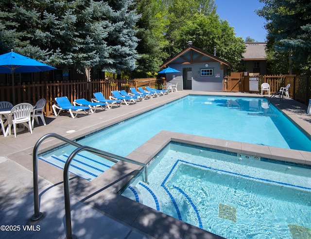 1404 Crazy Horse Cir Unit 1404, Edwards, CO 81632 - community pool featuring a community hot tub, a patio area, and an outdoor structure