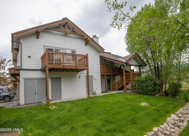 1404 Crazy Horse Cir Unit 1404, Edwards, CO 81632 - rear view of house with a chimney, a lawn, and stairs