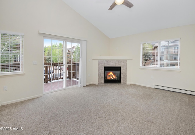 1404 Crazy Horse Cir Unit 1404, Edwards, CO 81632 - unfurnished living room featuring a ceiling fan, a premium fireplace, carpet flooring, a baseboard radiator, and high vaulted ceiling