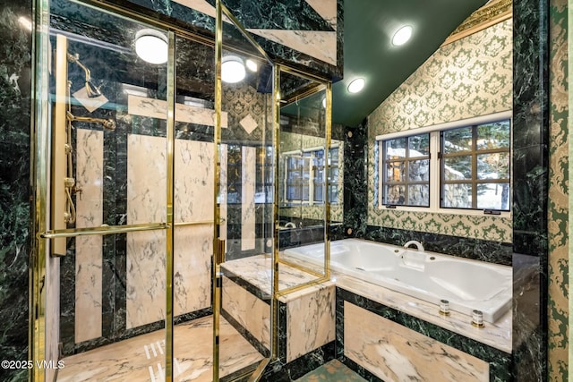 bathroom with a tub with jets and vaulted ceiling