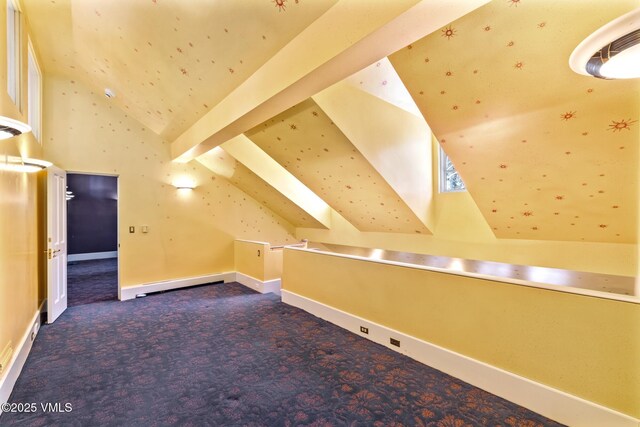 bonus room with baseboards, carpet floors, baseboard heating, and vaulted ceiling with beams