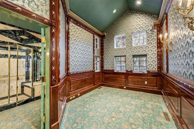 interior space with visible vents, wainscoting, wallpapered walls, and vaulted ceiling