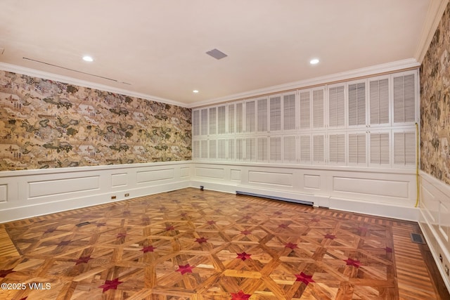 empty room featuring wallpapered walls, wainscoting, and ornamental molding