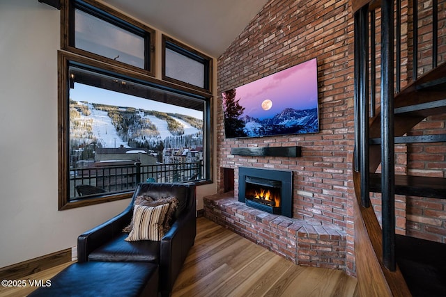 508 E Lionshead Cir Unit 502, Vail, CO 81657 - sitting room featuring wood finished floors, a fireplace, and lofted ceiling