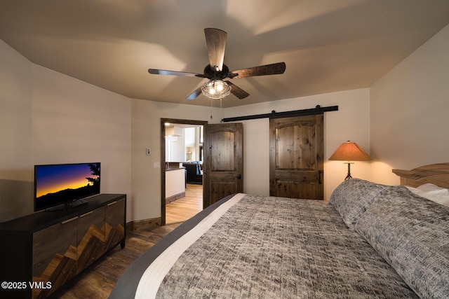 508 E Lionshead Cir Unit 502, Vail, CO 81657 - bedroom with wood finished floors, a barn door, and ceiling fan