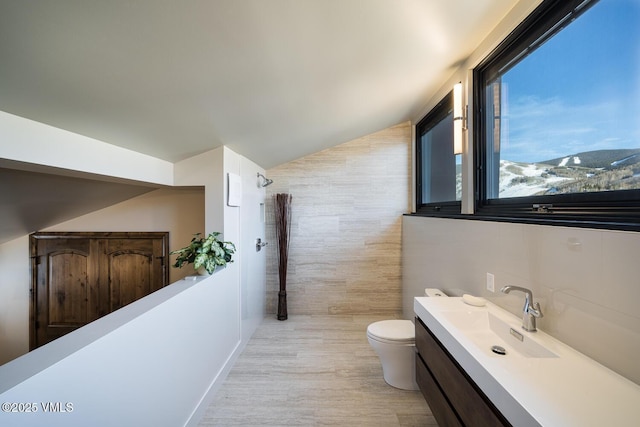 508 E Lionshead Cir Unit 502, Vail, CO 81657 - bathroom with vanity, tile walls, tiled shower, and wood finished floors