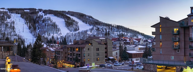 508 E Lionshead Cir Unit 502, Vail, CO 81657 - view of asphalt road featuring a mountain view, street lighting, curbs, and sidewalks