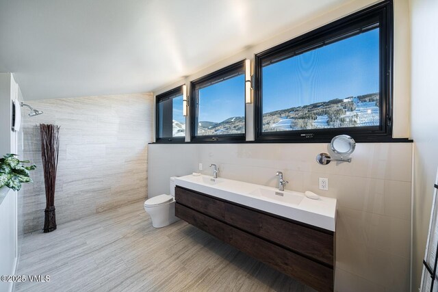 508 E Lionshead Cir Unit 502, Vail, CO 81657 - bathroom with tile walls, wood finished floors, and double vanity