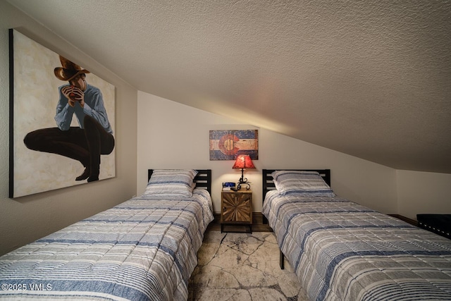 508 E Lionshead Cir Unit 502, Vail, CO 81657 - bedroom with lofted ceiling and a textured ceiling