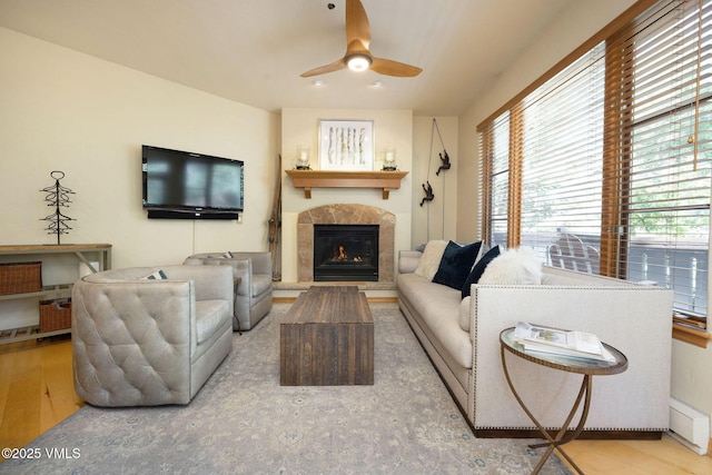 627 Sawatch Dr Unit 302, Edwards, CO 81632 - living area featuring a tile fireplace, a ceiling fan, and wood finished floors