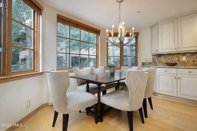 627 Sawatch Dr Unit 302, Edwards, CO 81632 - dining space with a chandelier, plenty of natural light, and light wood-style flooring