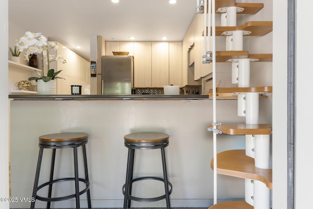 1552 Matterhorn Cir Unit 9, Vail, CO 81657 - kitchen with open shelves, a breakfast bar, recessed lighting, and dark countertops