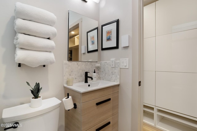 1552 Matterhorn Cir Unit 9, Vail, CO 81657 - bathroom featuring toilet, vanity, and decorative backsplash