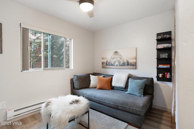 1552 Matterhorn Cir Unit 9, Vail, CO 81657 - living area featuring wood finished floors, a ceiling fan, baseboard heating, and baseboards