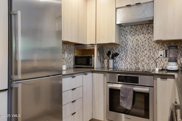 1552 Matterhorn Cir Unit 9, Vail, CO 81657 - kitchen featuring appliances with stainless steel finishes, under cabinet range hood, modern cabinets, and tasteful backsplash