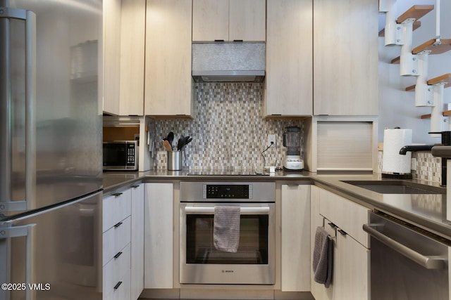 1552 Matterhorn Cir Unit 9, Vail, CO 81657 - kitchen with appliances with stainless steel finishes, a sink, tasteful backsplash, dark countertops, and modern cabinets