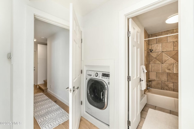 laundry room featuring laundry area, washer / dryer, and baseboards