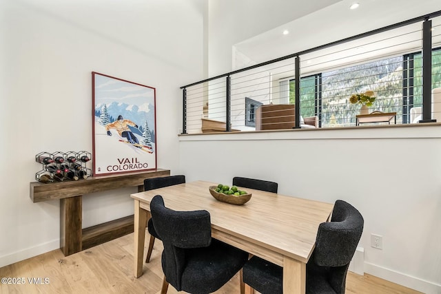 dining room featuring recessed lighting, baseboards, and wood finished floors