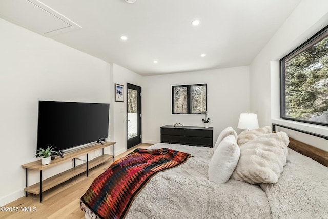 bedroom featuring attic access, recessed lighting, baseboards, and wood finished floors