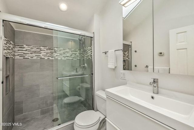 full bath with a shower stall, toilet, and vanity