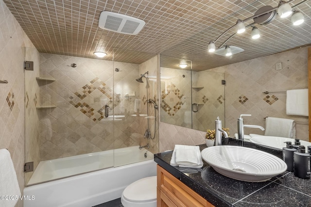 9 Vail Rd Unit 1J, Vail, CO 81657 - bathroom with tile walls, vanity, and enclosed tub / shower combo