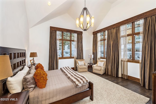 bedroom featuring a notable chandelier, dark wood-type flooring, and vaulted ceiling