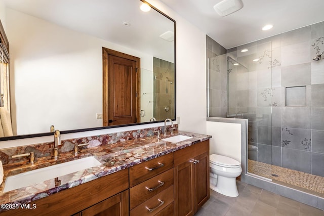 bathroom featuring tile patterned flooring, vanity, an enclosed shower, and toilet