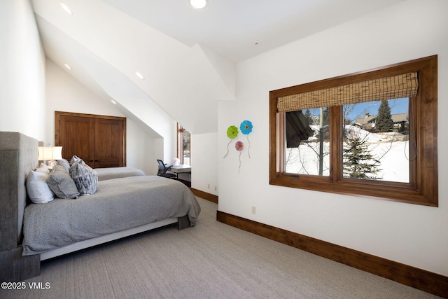 carpeted bedroom featuring lofted ceiling