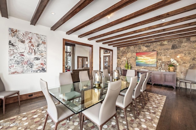 dining area featuring beamed ceiling and dark hardwood / wood-style floors