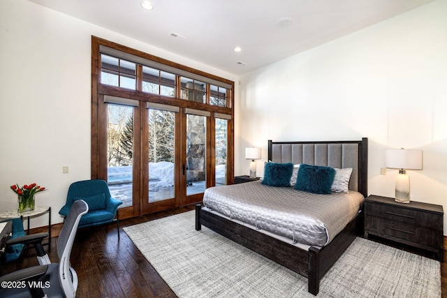 bedroom with access to exterior and hardwood / wood-style floors