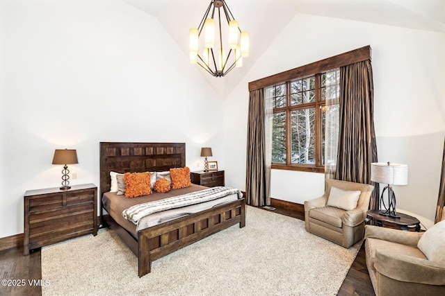 bedroom featuring wood-type flooring, a chandelier, and vaulted ceiling