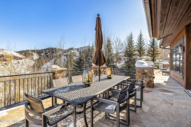 snow covered patio featuring a mountain view