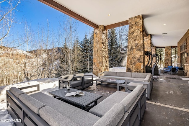 snow covered patio with an outdoor hangout area