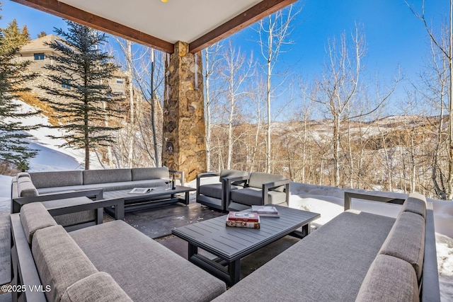 snow covered patio featuring an outdoor hangout area