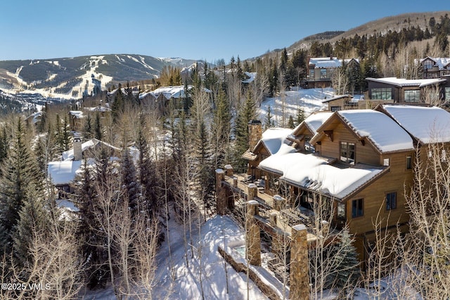 snowy aerial view featuring a mountain view