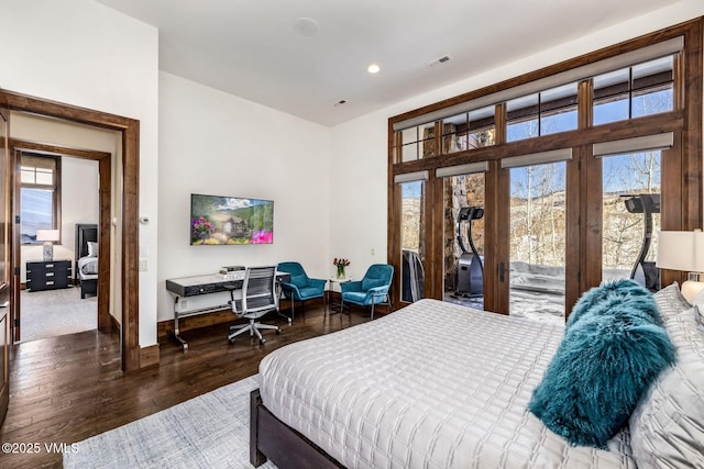 bedroom featuring dark hardwood / wood-style floors, access to exterior, and multiple windows