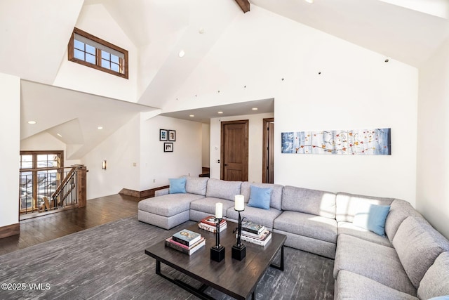 living room featuring beam ceiling, dark wood-type flooring, and high vaulted ceiling