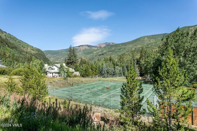 view of tennis court featuring a mountain view