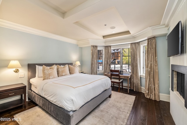 1 Willow Bridge Rd Unit 36, Vail, CO 81657 - bedroom with a tray ceiling, hardwood / wood-style floors, a fireplace, baseboards, and crown molding
