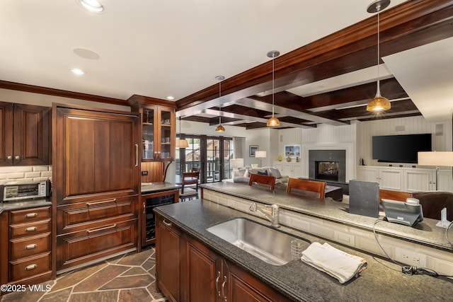 1 Willow Bridge Rd Unit 36, Vail, CO 81657 - kitchen featuring wine cooler, a sink, decorative light fixtures, open floor plan, and glass insert cabinets