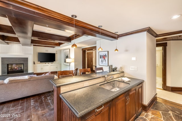 1 Willow Bridge Rd Unit 36, Vail, CO 81657 - kitchen featuring a sink, baseboards, beam ceiling, hanging light fixtures, and a peninsula