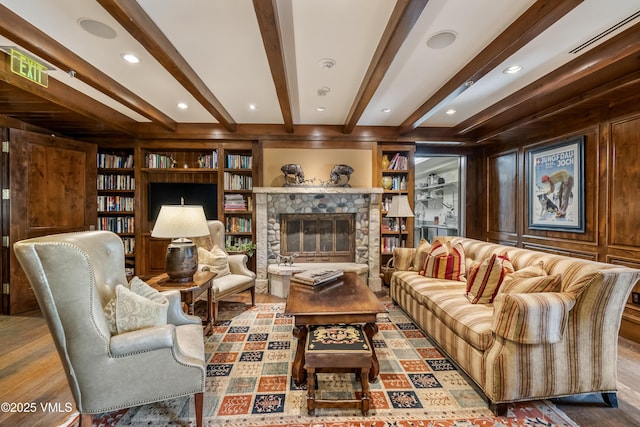 1 Willow Bridge Rd Unit 36, Vail, CO 81657 - living area with beamed ceiling, wood finished floors, a stone fireplace, and built in features