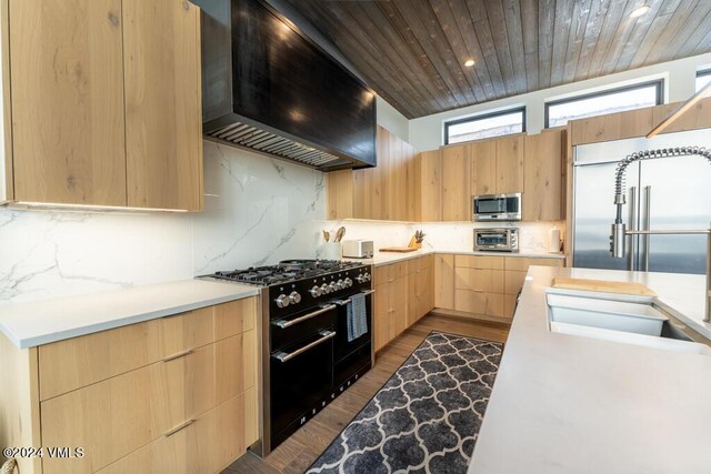 kitchen featuring high quality appliances, decorative backsplash, wood ceiling, light brown cabinets, and wall chimney exhaust hood