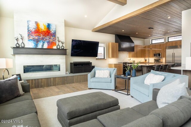 living room featuring sink and lofted ceiling with beams